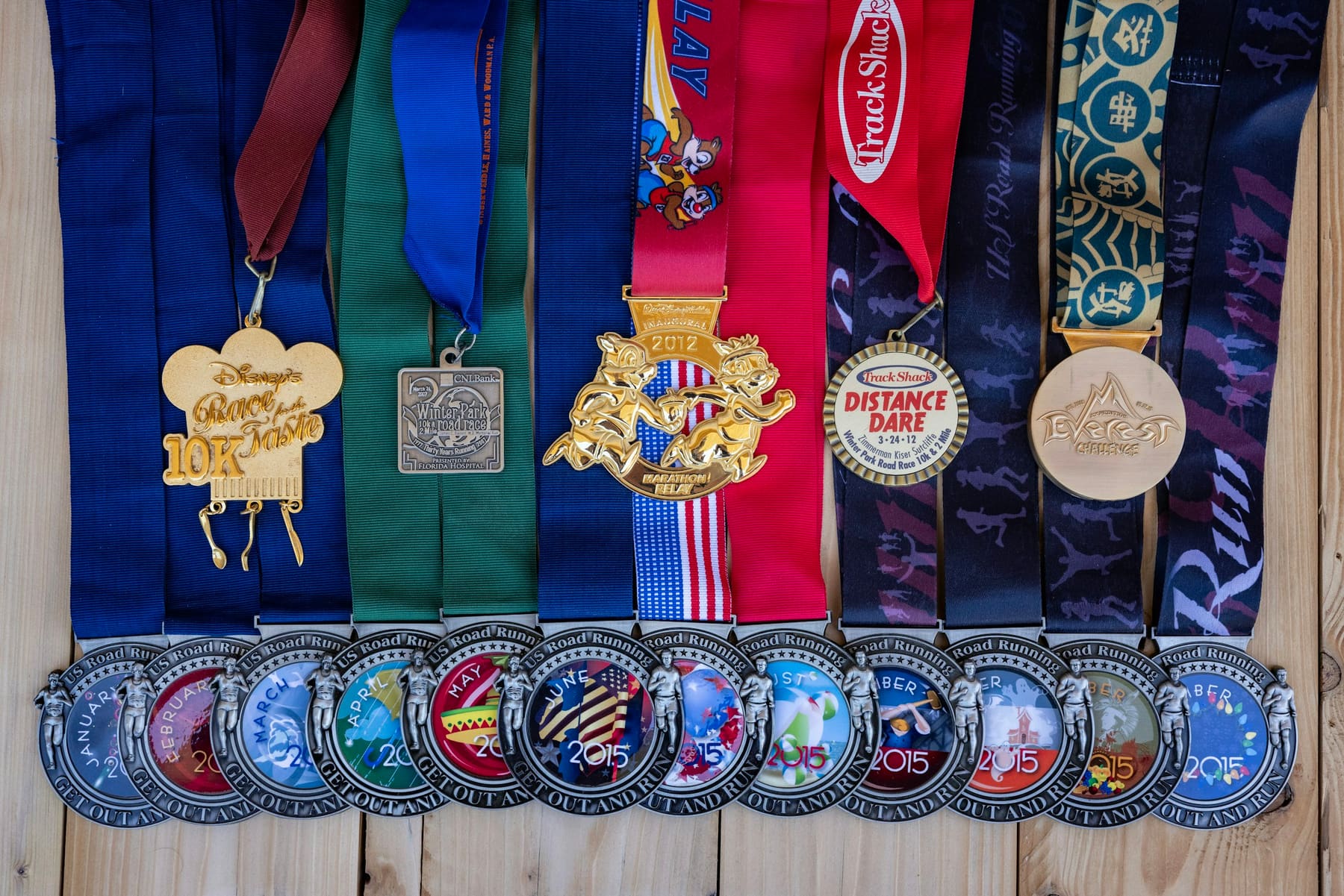 Collection of race medals hanging on their ribbons